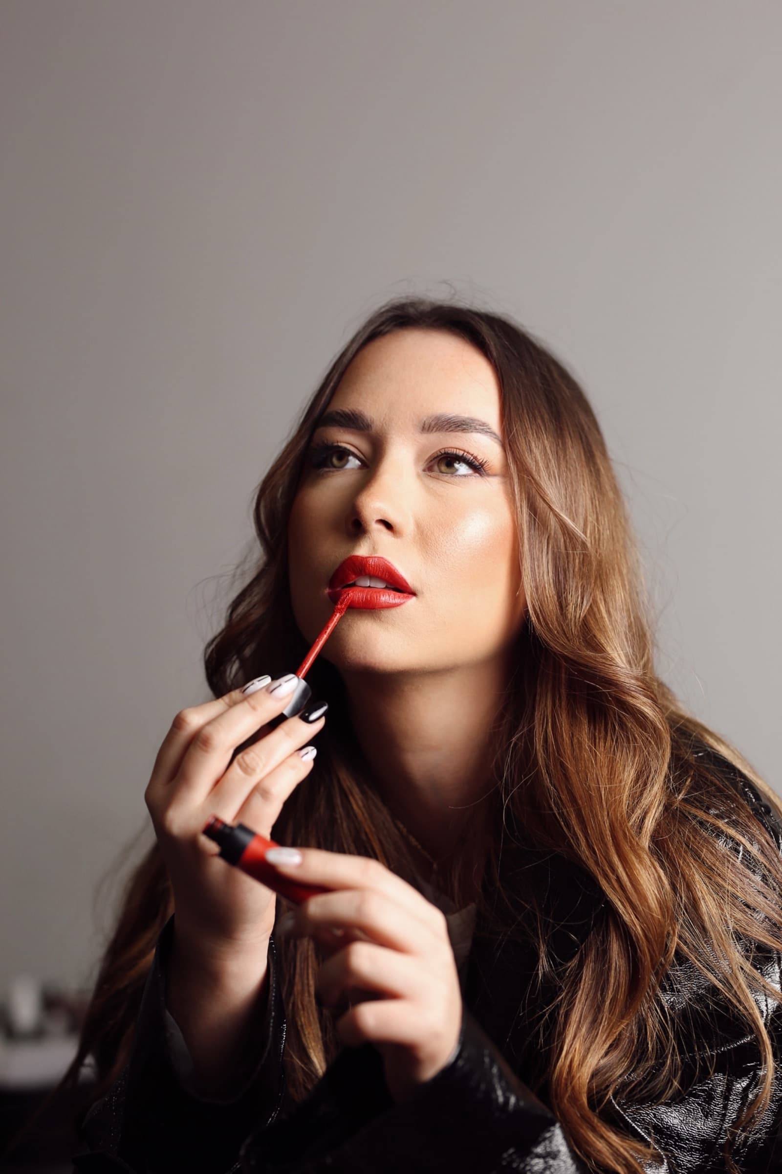 Red lipstick drawn on, eyes lifted away
