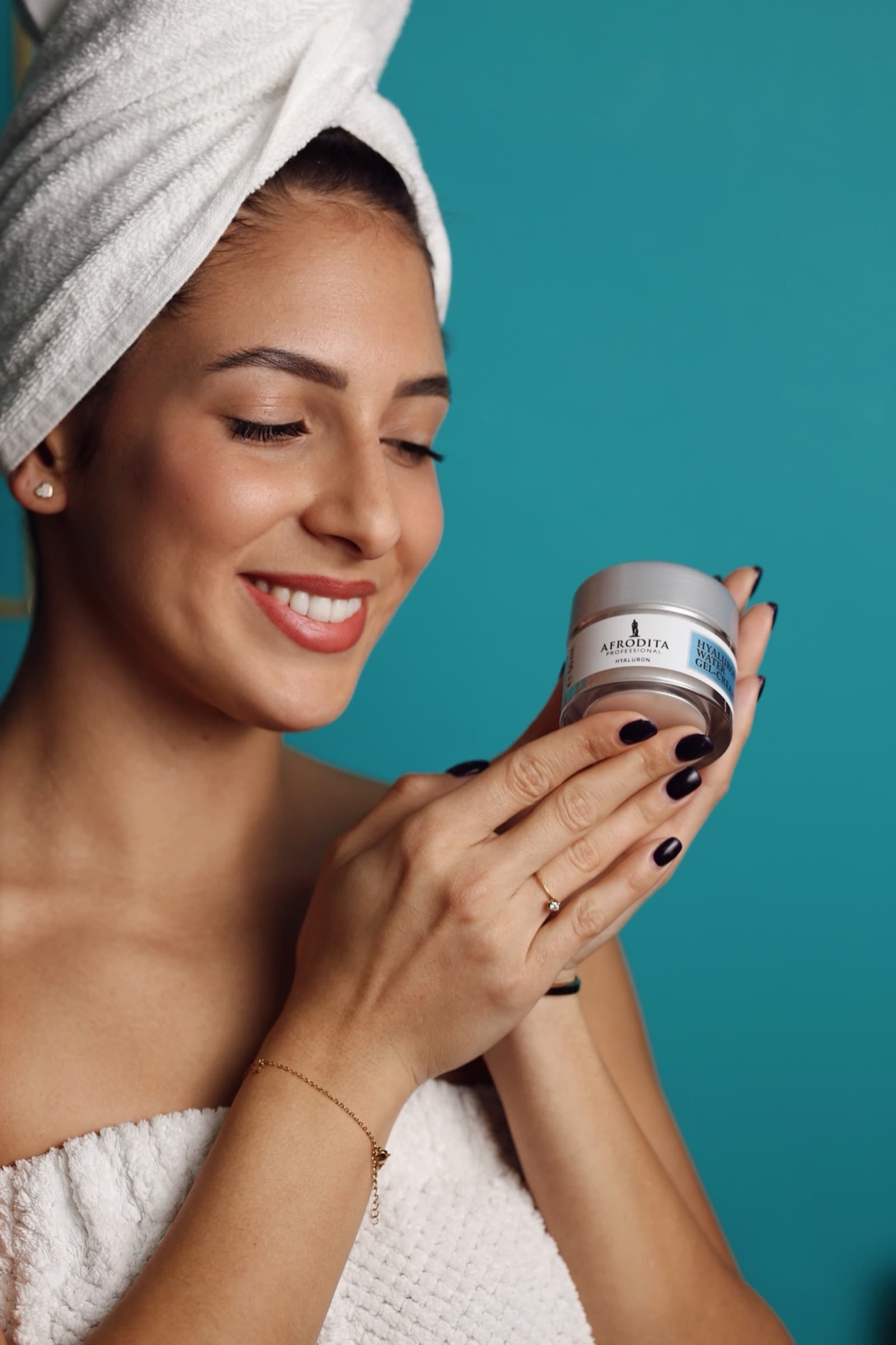 Presenting a jar of cream against a teal wall