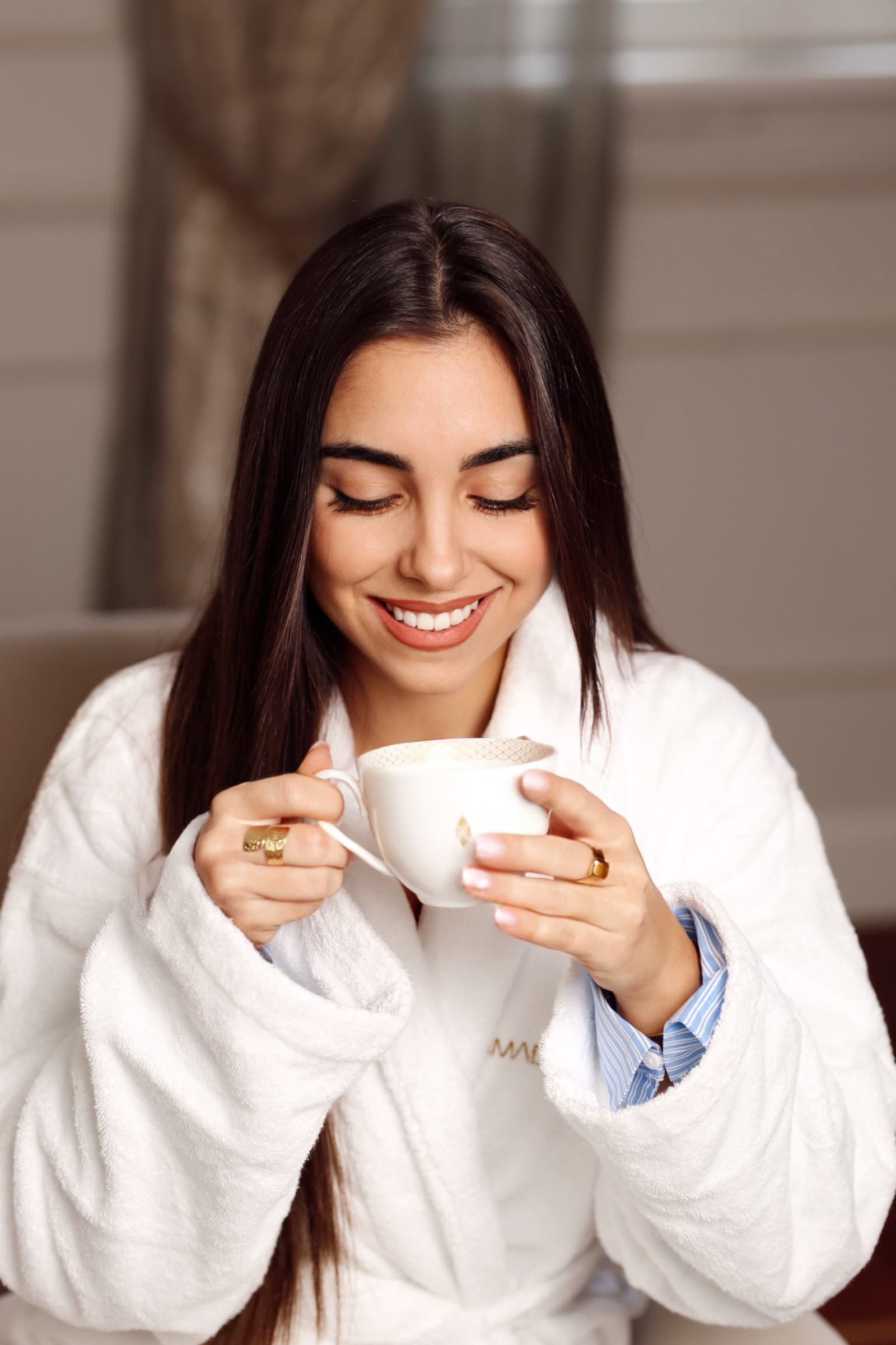 Eyes closed over the first sip of morning coffee