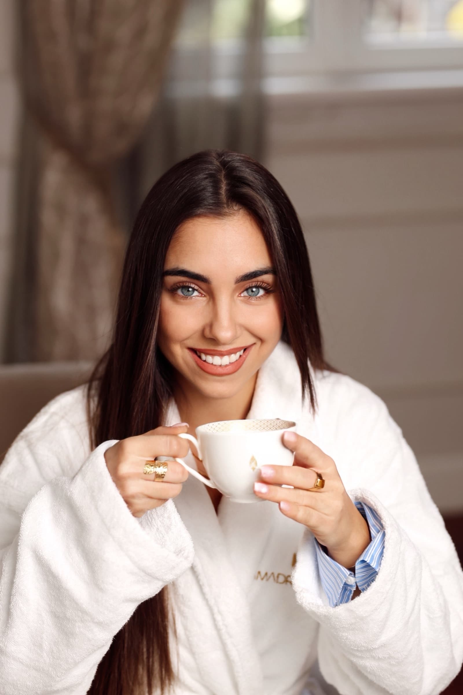Portrait with cappuccino against the suite's soft panelling