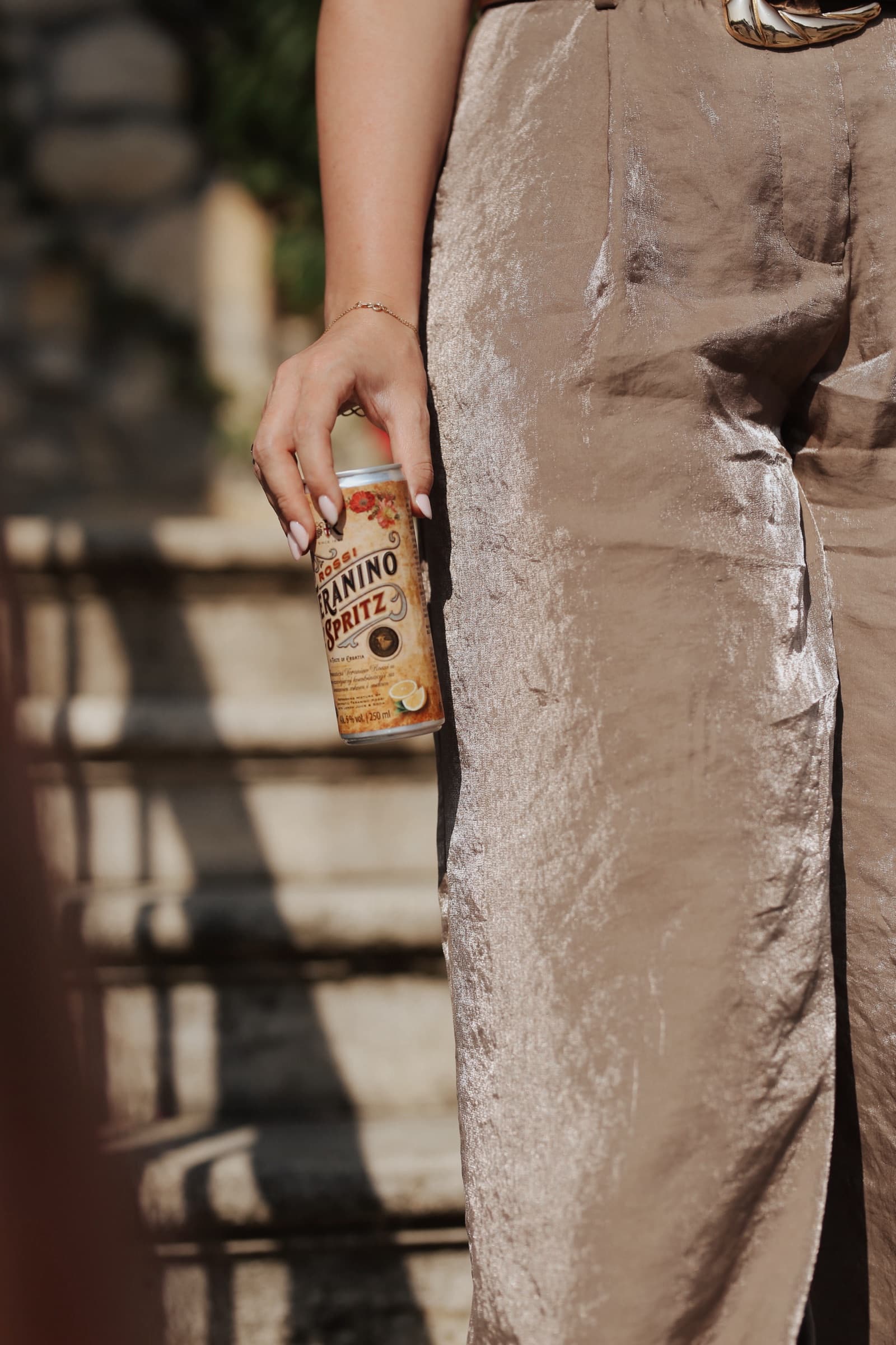 Teranino Spritz carried down stone steps in champagne satin