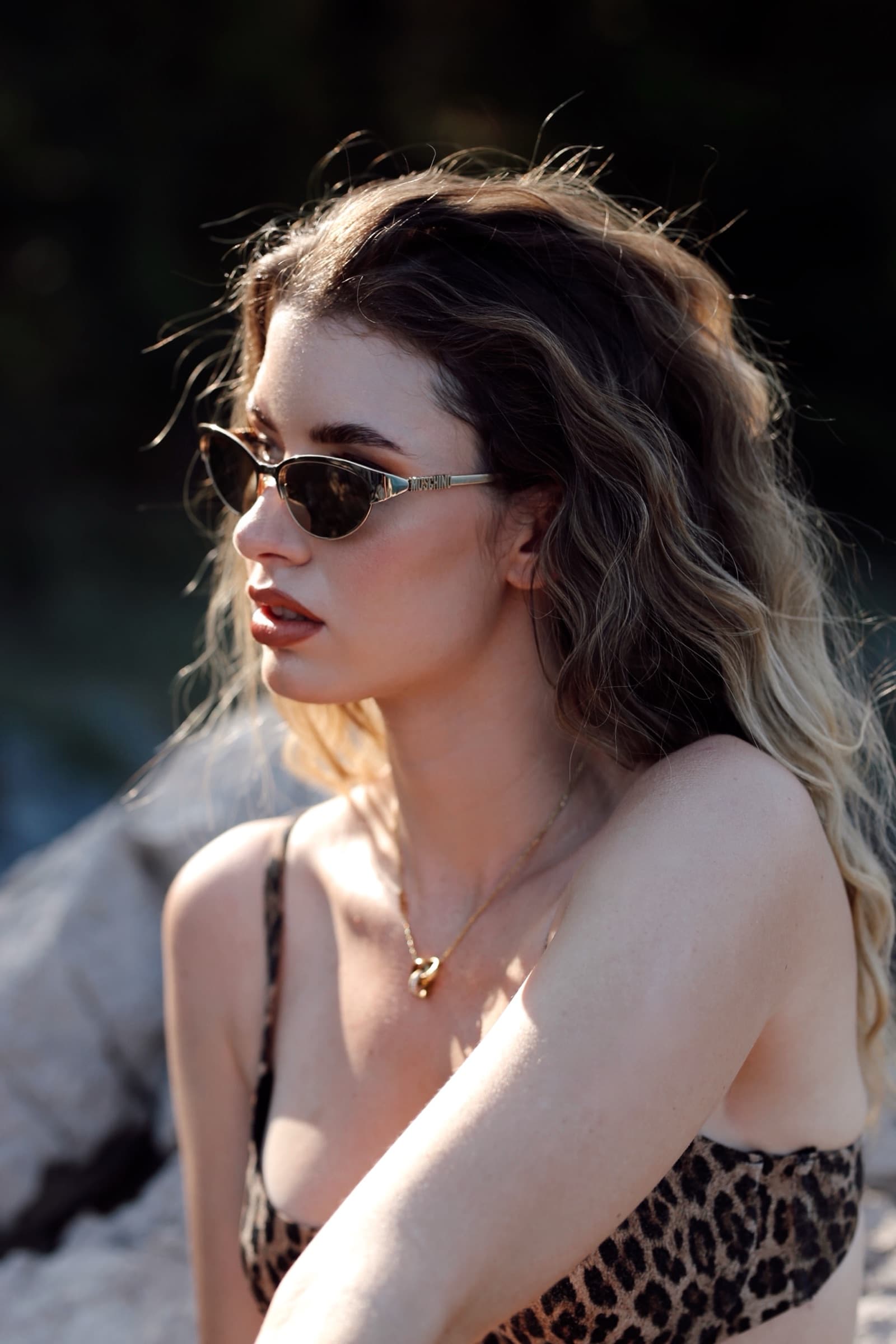Slim cat-eye sunglasses, leopard print, hair caught in the wind