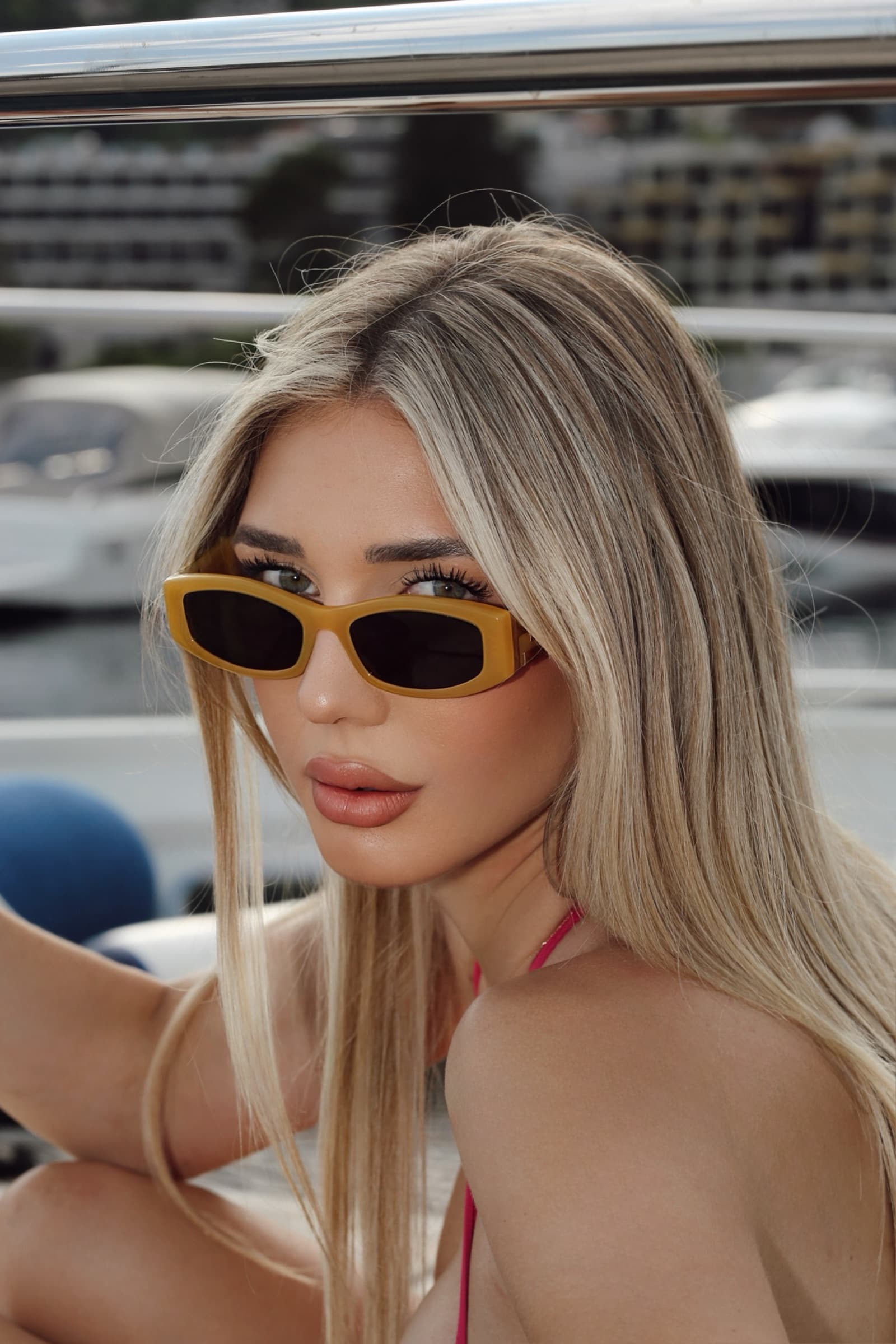 Yellow rectangular sunglasses at the marina