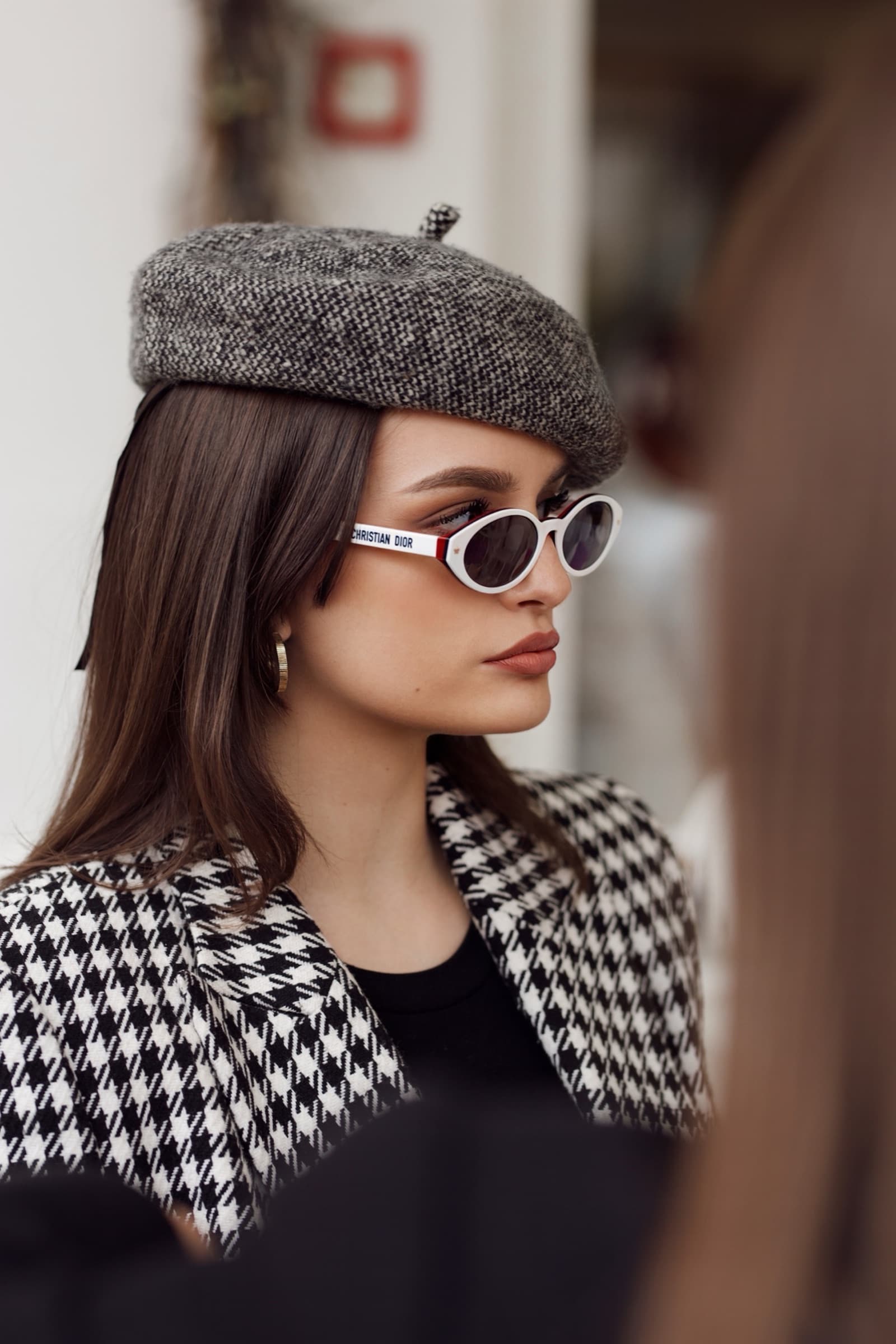 White oval sunglasses with a tweed beret and houndstooth coat