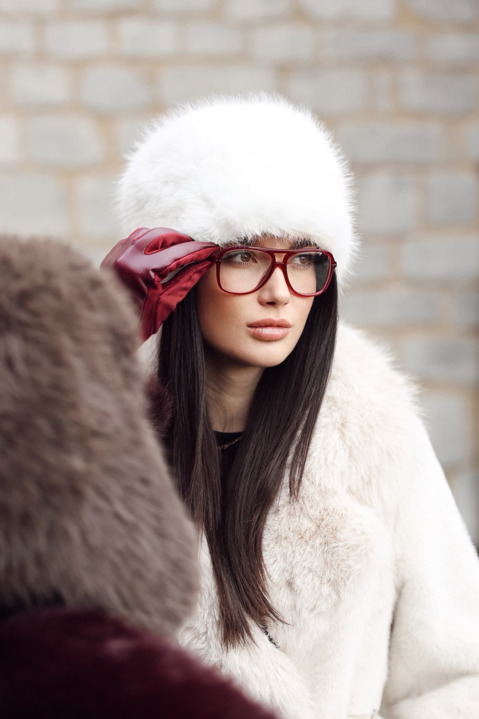 Red optical frames with a white fur hat and red ribbon