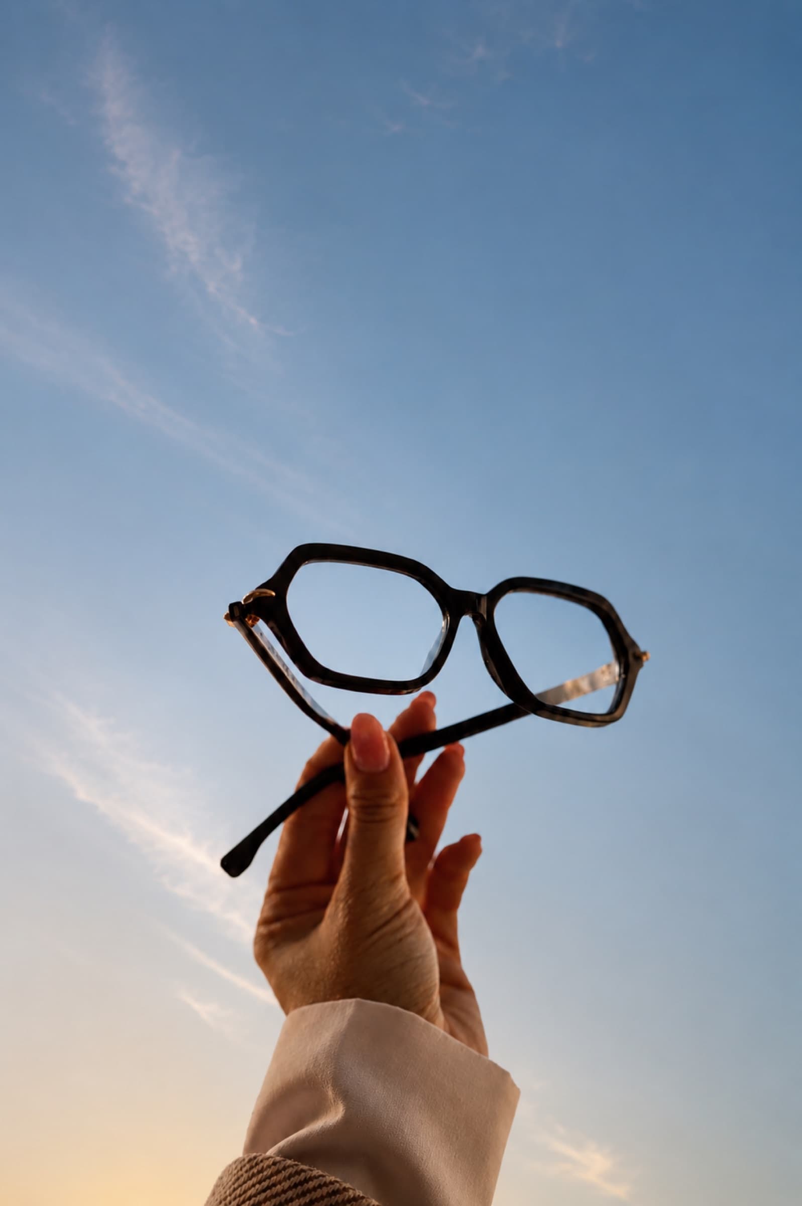 Optical frames held up against an open sky