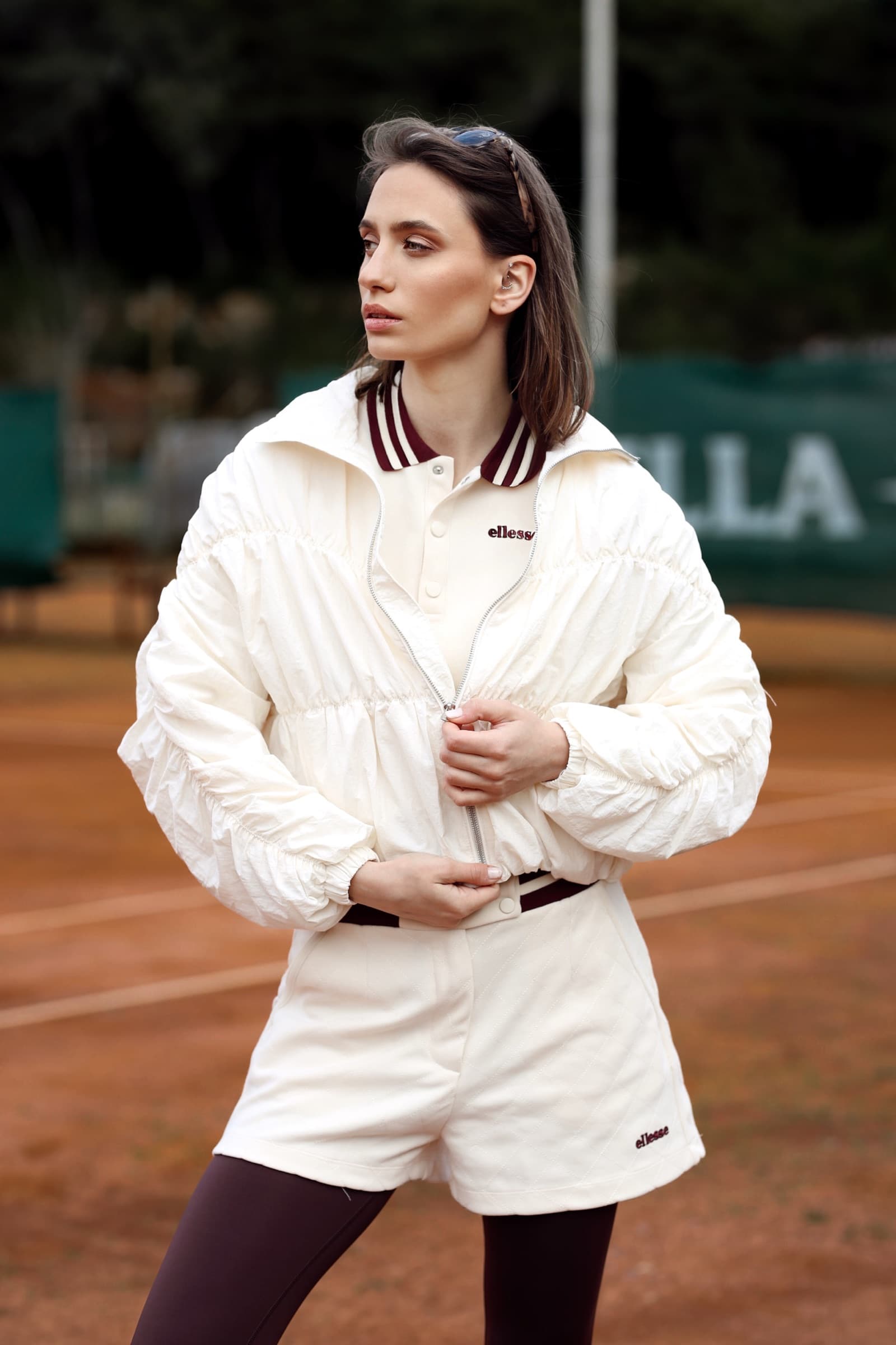 Cream track jacket and shorts on the clay court