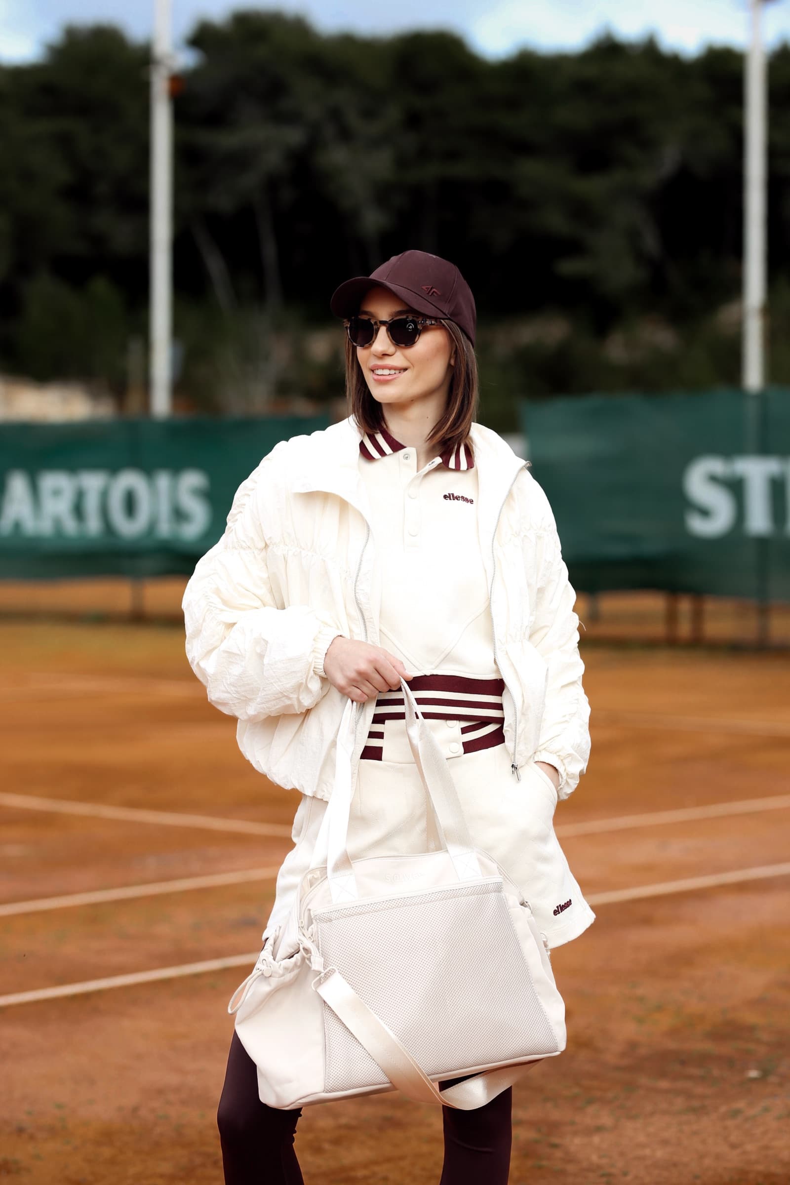 Cream tracksuit and shoulder bag courtside