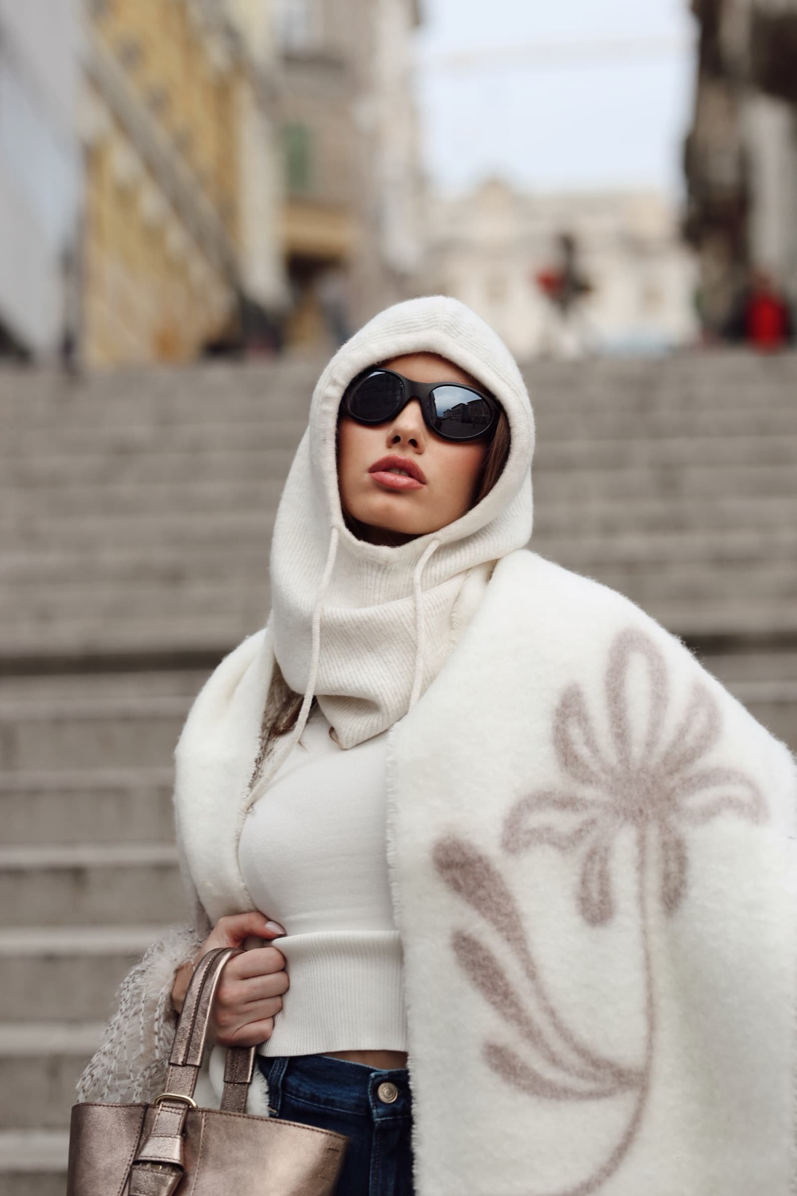 Hooded cream knit and sunglasses on the old town steps