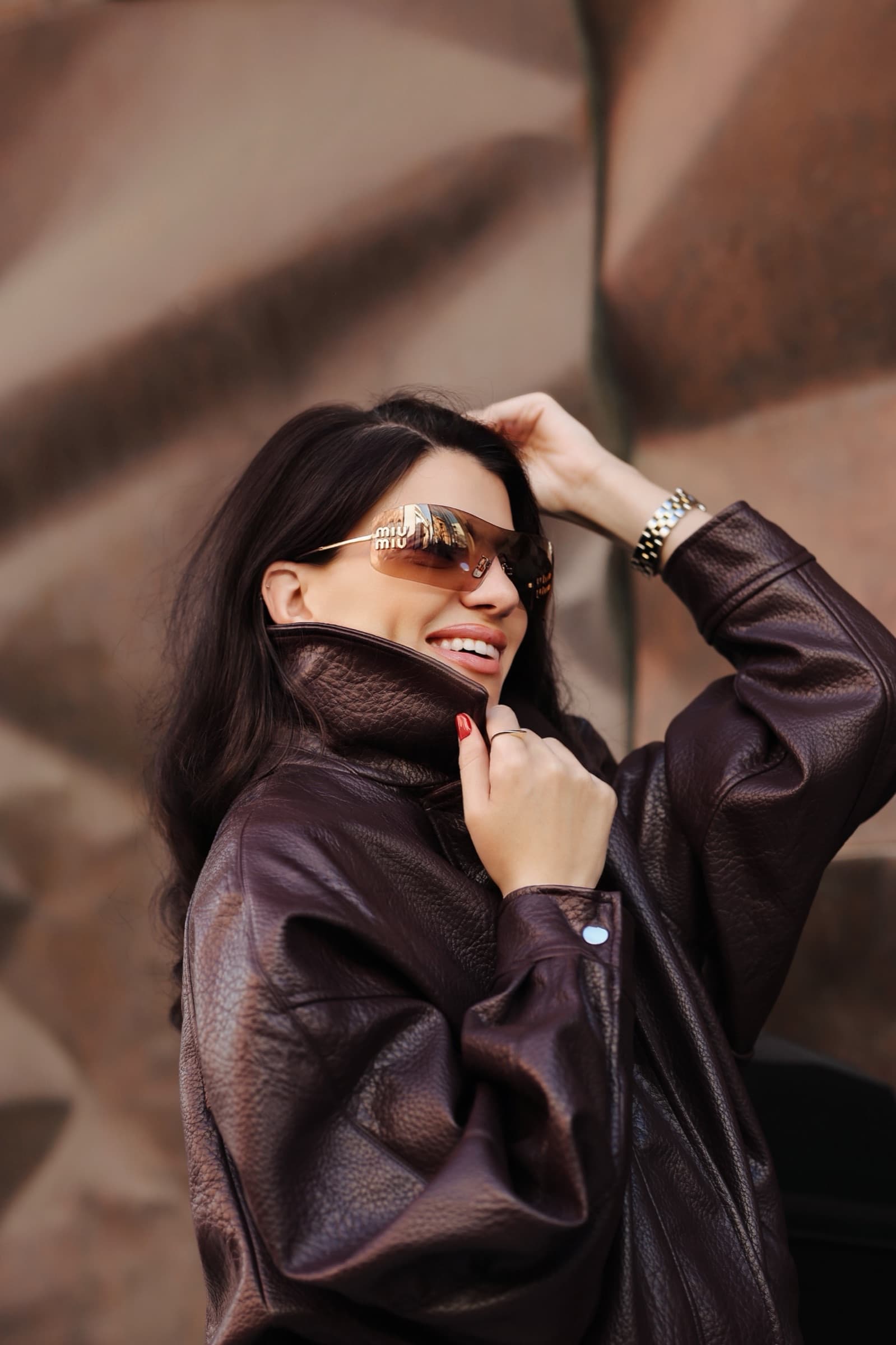 Chocolate leather jacket and tinted sunglasses