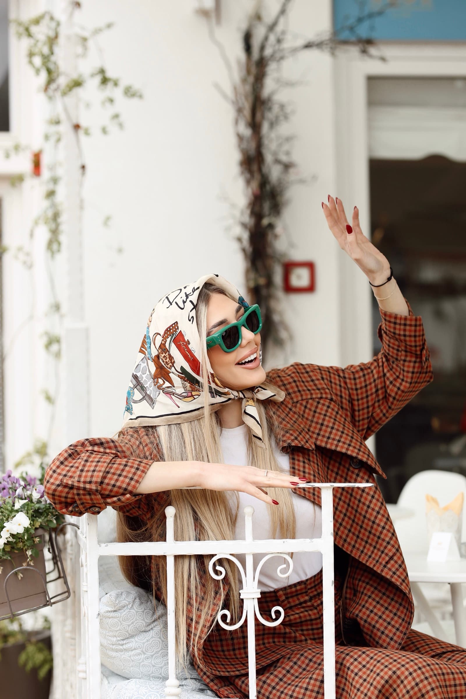 Printed headscarf and green sunglasses in a check suit