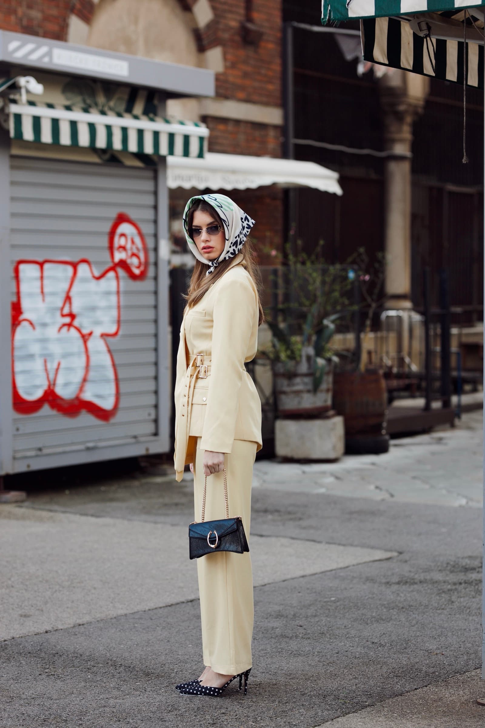 Full-length cream suit and headscarf on the street